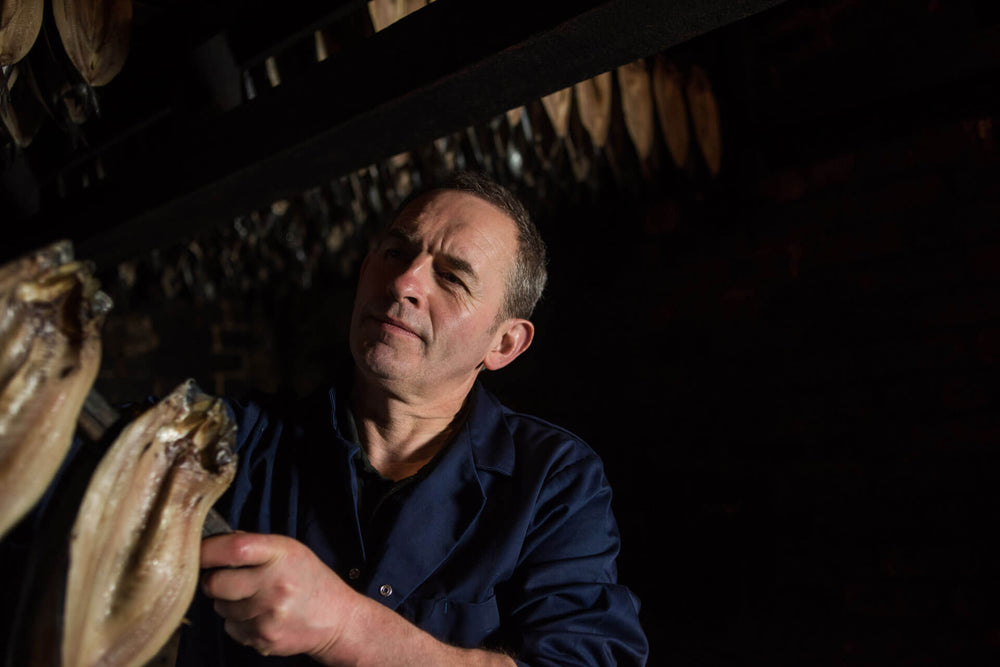 George with our Mallaig kippers in the smokehouse that has been around since our inception.